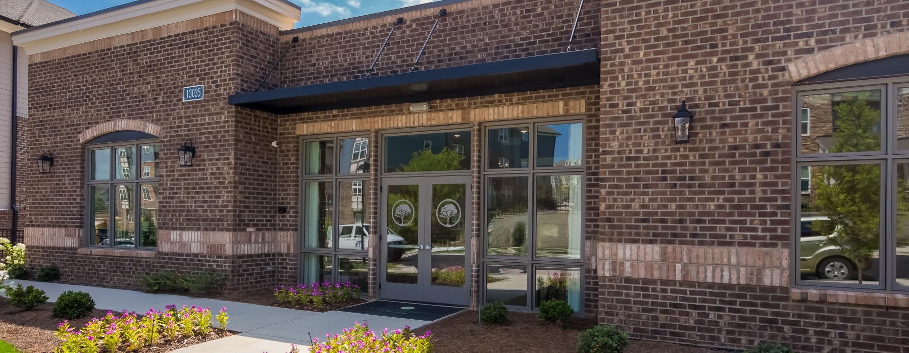 a brick building with glass doors