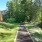 a walking path with grass and trees