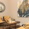 a room with a few chairs and a painting