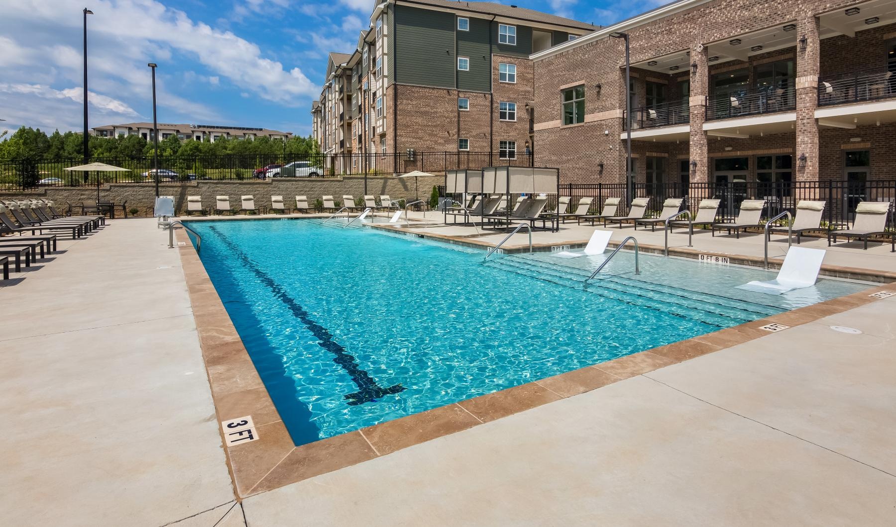 Relax and unwind poolside a swimming pool in a courtyard